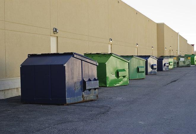 metal waste containers sit at a busy construction site in Clintondale